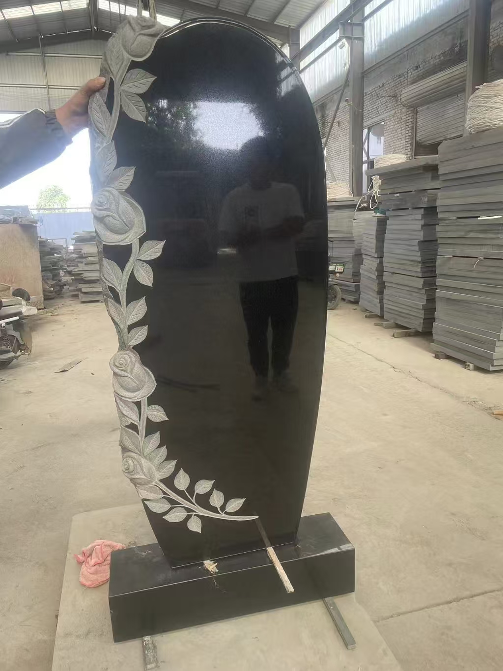 black granite headstone trimed with white carved roses.jpg